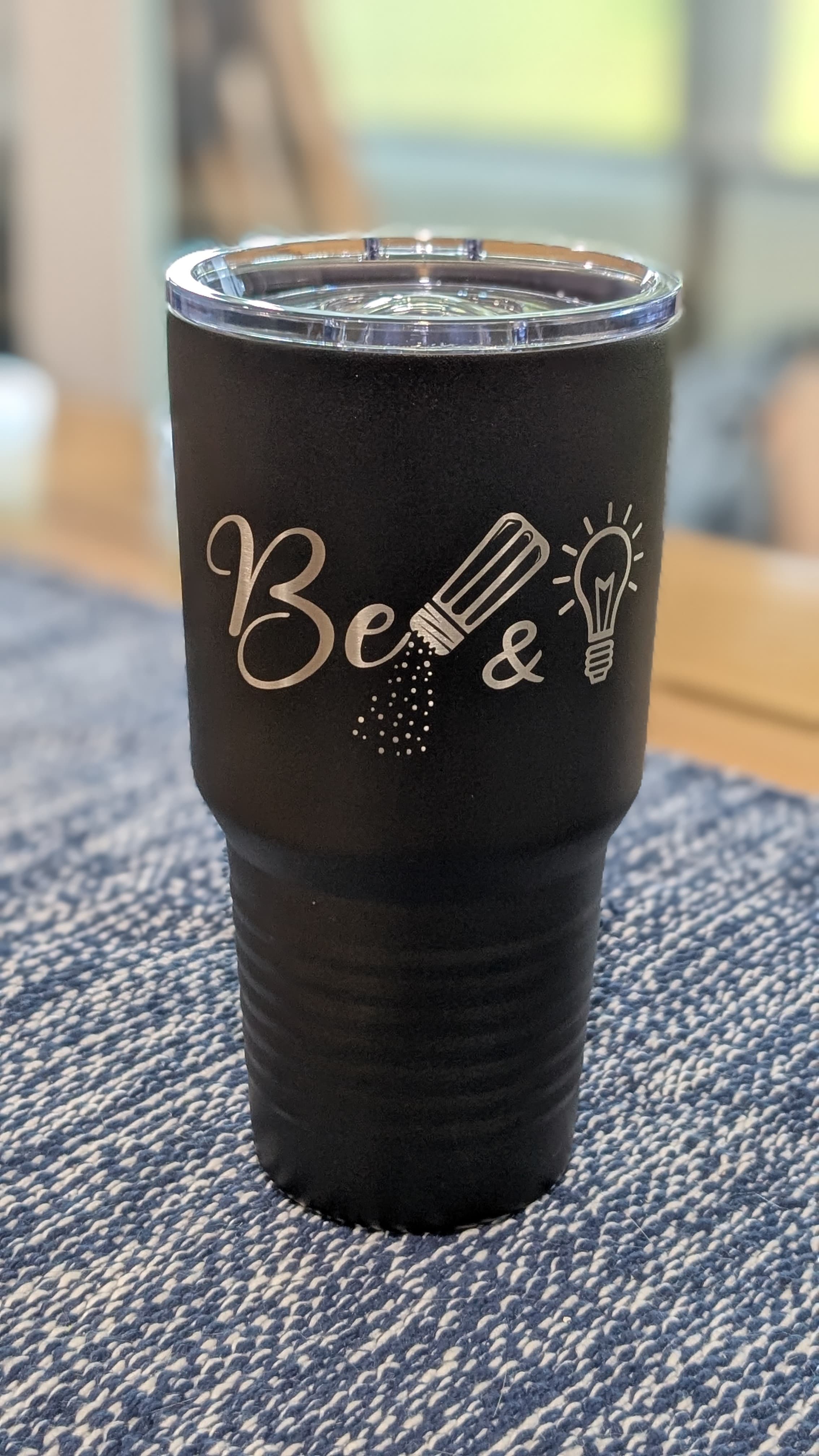 Three small plants being held by hands